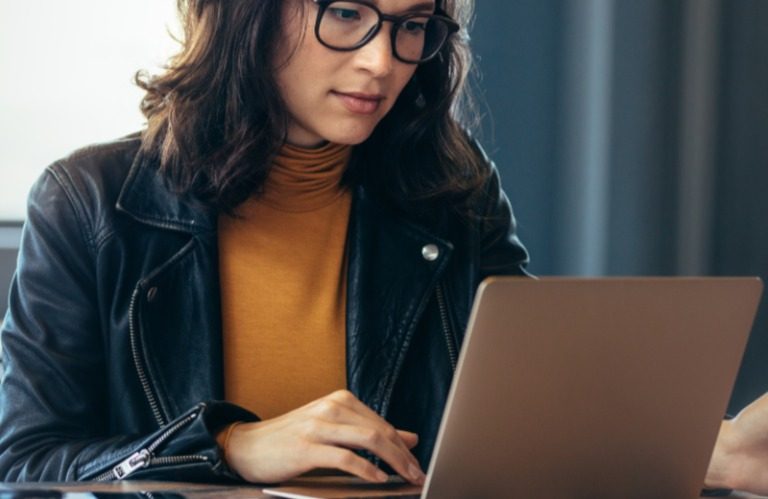 Woman using her laptop to access KeHE shows