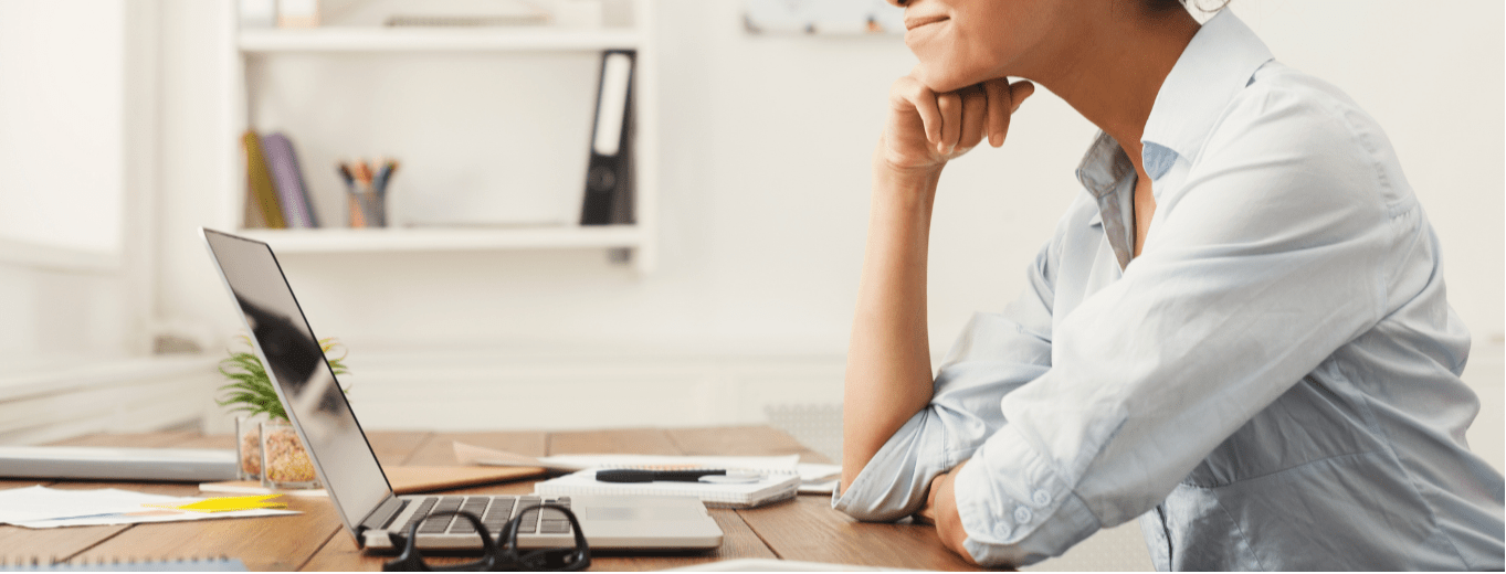 Happy business woman working on laptop at office