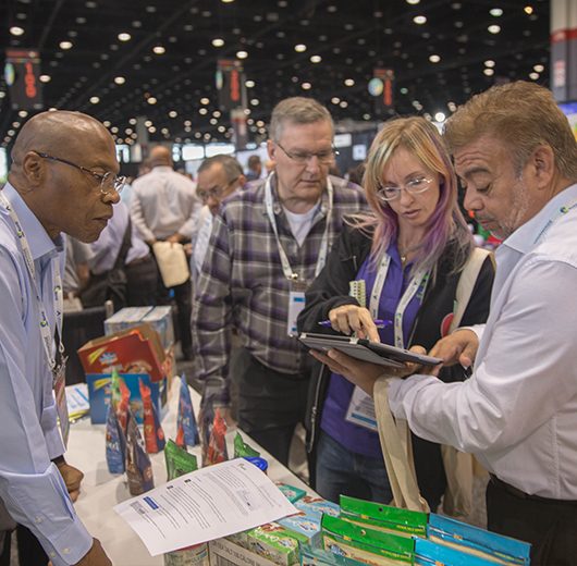 KeHE show attendees ordering at an exhibitor booth