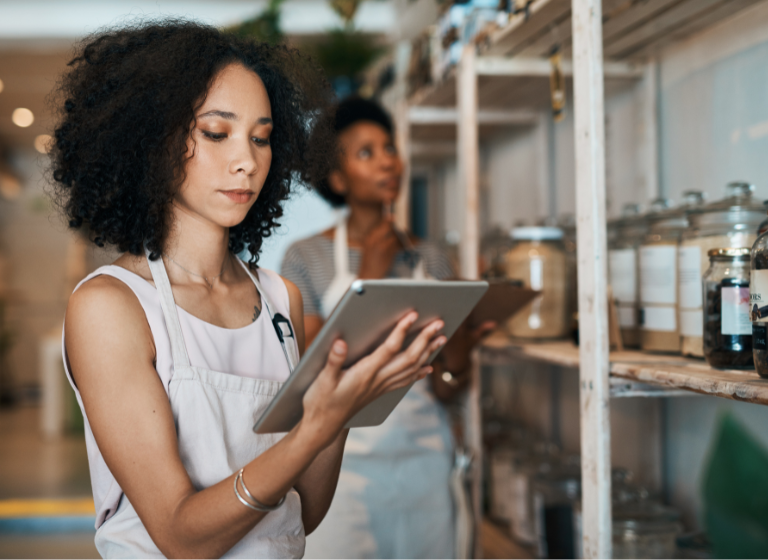 woman checking shelves tablet