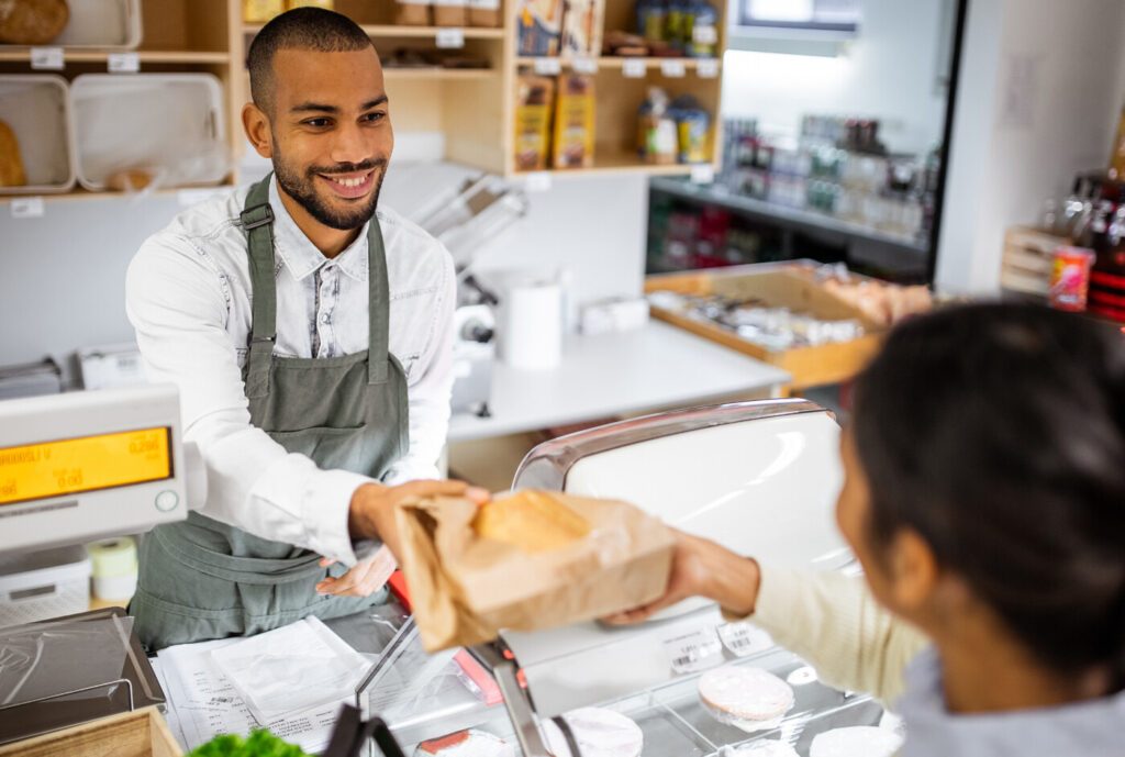 Customer paying for groceries at the cash register