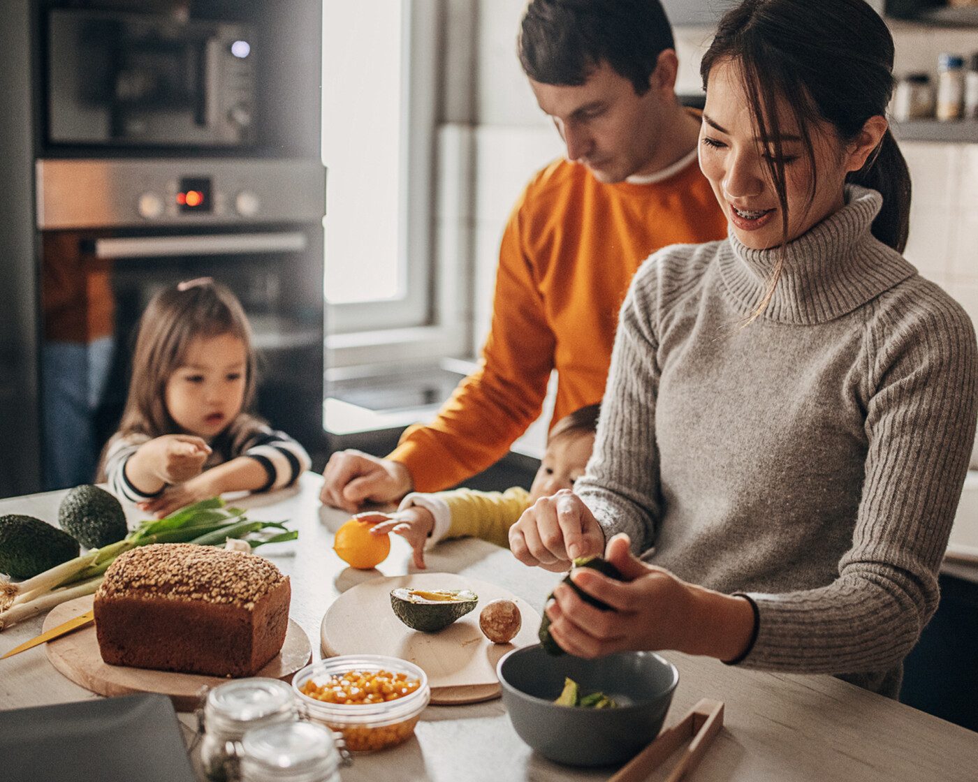 Family standing at counter with food