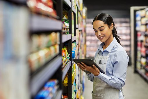 woman walking in store looking at tablet